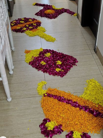 Beyond balloons, I also create custom designs using flower petals. This photo shows intricate rangoli-style art made from marigold and rose petals on the floor, perfect for a traditional welcome or festive occasion.