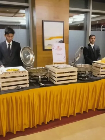 Our team setting up a buffet for a house warming party at Auris Serenity. We use rustic wooden crates and elegant chafing dishes to create a stylish yet functional food station.