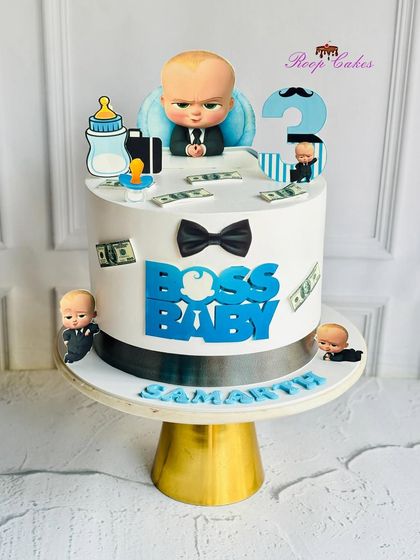 This Boss Baby cake means business for a 3rd birthday. The design includes the boss himself, along with his briefcase, bottle, and edible money, creating a fun and commanding presence.