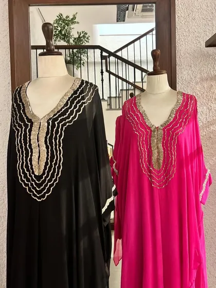 Showcasing the effortless elegance of our kaftan collection. The flowing silhouettes in bold pink and classic black are accented with delicate neckline embroidery, offering comfort without compromising on style.