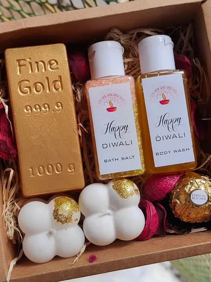 A luxurious Diwali gift box with a "Fine Gold" bar soap, bubble soaps, bath salt, body wash, and a Ferrero Rocher.