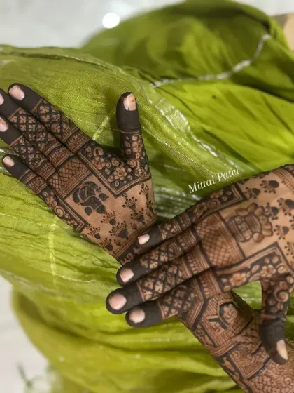 A beautiful back of hand design with a focus on traditional motifs like elephants and checks. The dark, rich stain makes the intricate details pop against the skin.