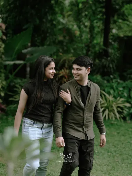 The couple enjoying a walk in the garden, their relaxed smiles and easy companionship shining through.
