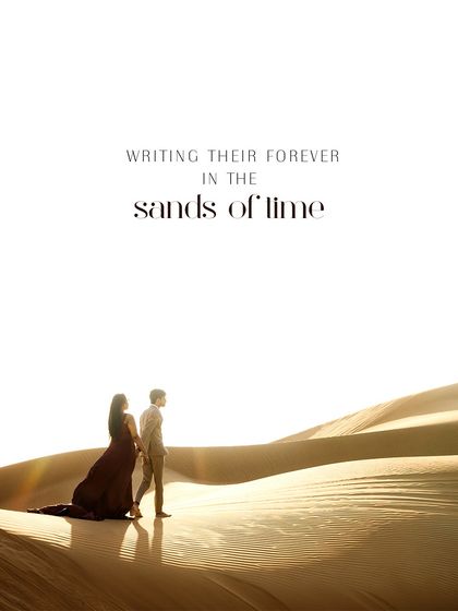 Writing their forever in the sands of time. This epic shot from their Dubai desert pre-wedding shoot features the bride in a dramatic crimson gown against the sweeping dunes.
