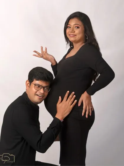 A playful and happy moment captured in timeless black and white. His excitement as he listens to the bump is contagious.