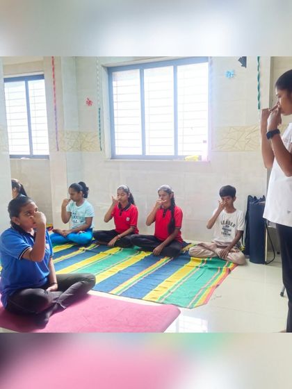 Here, one of our young students guides her peers in Anulom Vilom pranayama, or alternate nostril breathing. We encourage children to not only learn but also share their knowledge, which builds their confidence and deepens their own understanding of the practice.