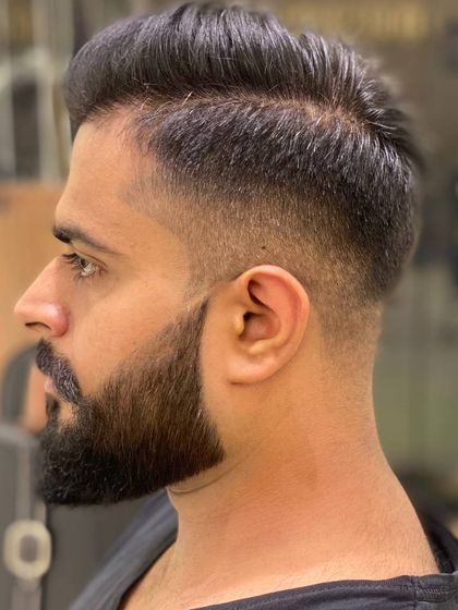 Another angle of a sharp men's haircut, showing the clean lines and expert styling that transforms the ordinary into the extraordinary.