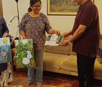 Receiving a certificate of participation at the Wayanad art camp. I'm holding my painting of hydrangeas inspired by the local flora.