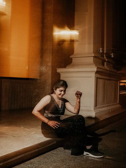 A fun, candid moment captured with motion blur. The bride's joyful expression is the focus, while the blurred lights around her convey the energy of the party.