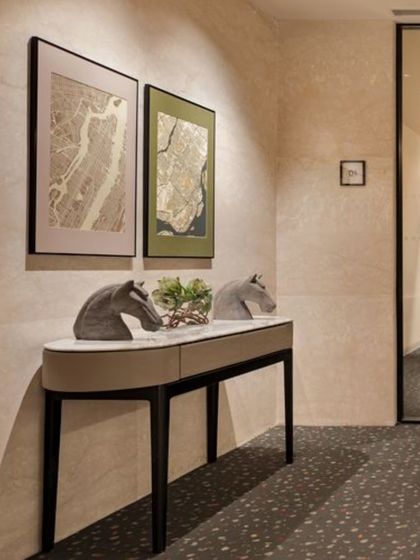 A detail of the mezzanine level at the Elevate Clubhouse, where curated art and a sleek console table create a moment of visual interest. The terrazzo flooring adds texture and durability.