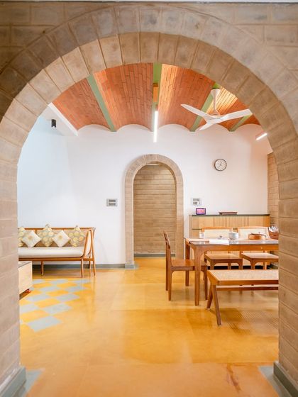 An archway frames the view into the dining area, creating a layered effect.