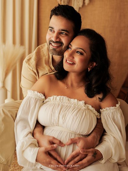 The heart hands pose is a classic for a reason. It's a beautiful symbol of the love you already have for your baby, captured here in a tender moment between partners.