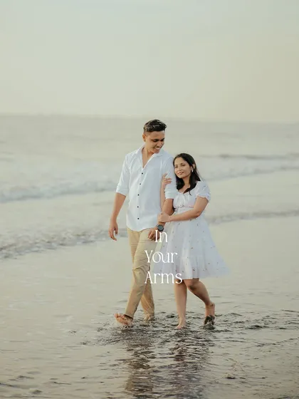 Finding my home in your arms. A romantic pre-wedding photo capturing a tender embrace as the couple walks through the gentle waves at sunset.