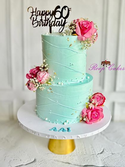 Sweet celebrations in pastel hues for the most beautiful Mom on her 60th birthday. A lovely two-tier cake in mint green with pink flowers.