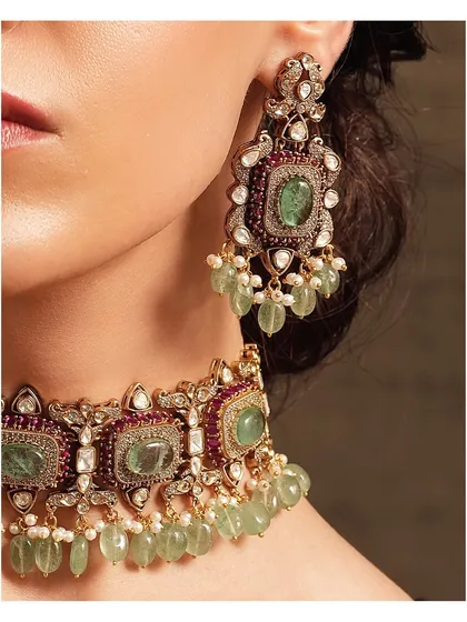 A close-up of the emerald and ruby choker set, highlighting the intricate setting and the vibrant color combination.