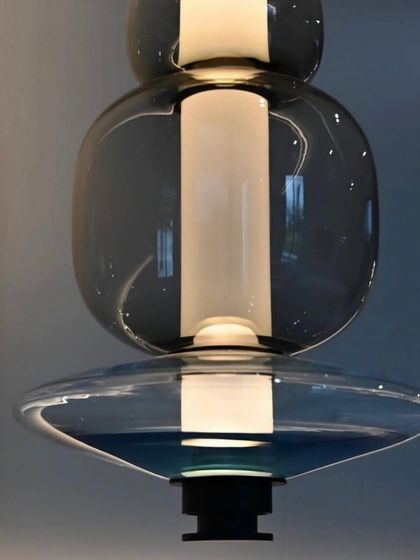 This image details the deep blue and clear glass combination of a Luna pendant, showcasing the vibrant color options available.