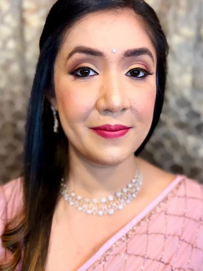 The final look for the sister of the bride. The makeup is soft, enhancing her features and giving her a healthy glow.