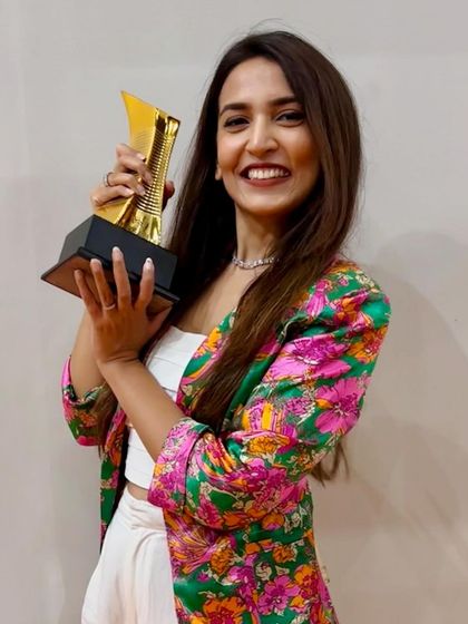 Maha proudly holding our Gold Award from Wade Asia 2024.