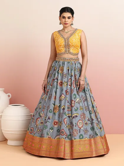 A closer look at the grey floral lehenga with the yellow V-neck blouse, showcasing the intricate embroidery and the beautiful print.