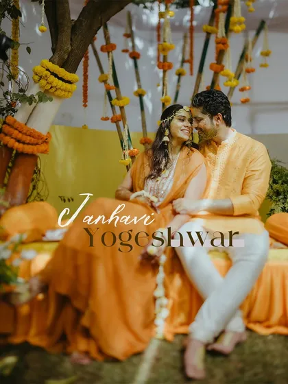A romantic portrait of the couple seated together, sharing a quiet moment amidst their Haldi decorations.