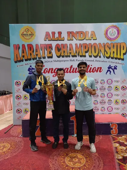 Harshit and Tushar with their medals and the team trophy at the National Karate Championship.