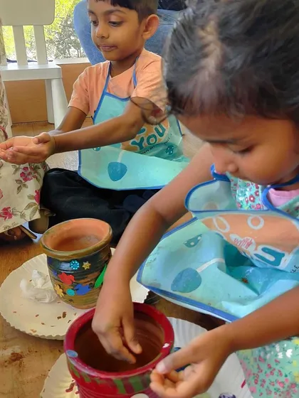 A close-up of a child participating in the gardening workshop, showing the concentration required for this delicate task.