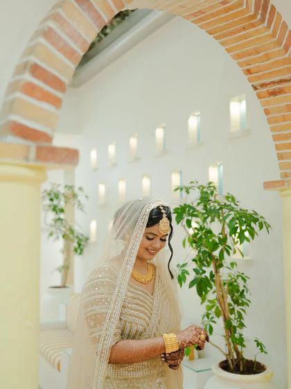 Soft, glowy, and minimal for a beautiful Nikaah ceremony. The makeup enhances her features without being overpowering, perfect for the serene and elegant occasion.