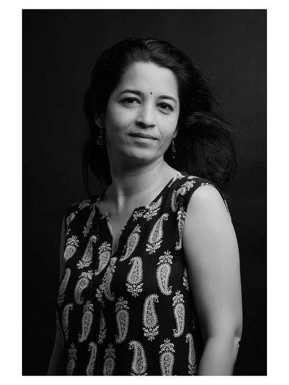 A thoughtful and serene expression, beautifully rendered in a black and white studio setting.