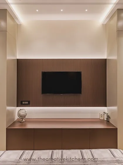 This image shows the wardrobe as part of a complete wall unit, flanking a custom TV console. This demonstrates our ability to create fully integrated furniture solutions that maximize storage and maintain a cohesive design.