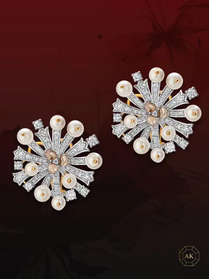 These abstract statement earrings are designed in 18k gold and adorned with rose-cut diamonds, round diamonds, and radiant South Sea pearls.