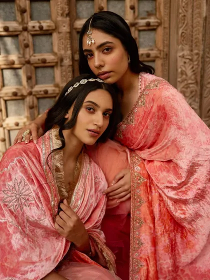 A warm, intimate portrait for Ruhr, showcasing velvet robes. The composition and soft lighting emphasize the rich texture of the fabric and the connection between the models.