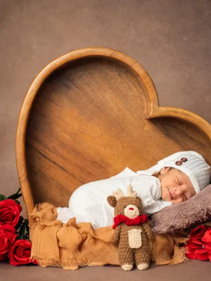A Valentine's themed newborn shoot featuring our son. The heart-shaped wooden bowl and red roses create a warm and loving atmosphere.