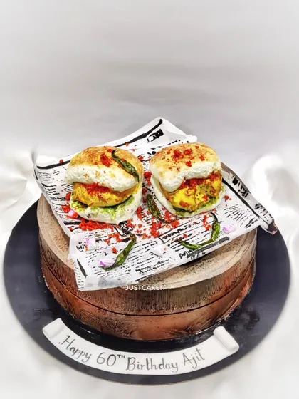 I love a creative challenge, like this hyper-realistic Vada Pav cake made for a 60th birthday. Everything you see, from the pav to the chillies, is completely edible and sits on top of a delicious butterscotch cake.