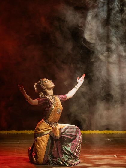 Reaching towards the heavens in a moment of spiritual connection during a performance. The use of smoke and dramatic lighting enhances the otherworldly feel of the piece.