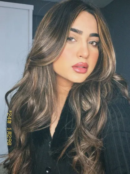 A stunning example of a Hazelnut brown hair color with highlights. This look is incredibly flattering and adds a beautiful warmth to the overall style.