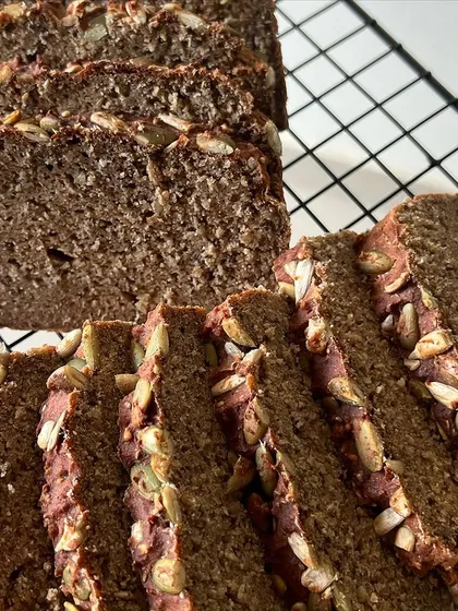 Freshly sliced and ready to eat. You can see the generous amount of seeds baked right in, offering a satisfying crunch and a boost of healthy fats in every bite of this gluten-free loaf.