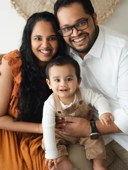 A classic, happy family portrait. The close-up framing emphasizes their smiles and connection.
