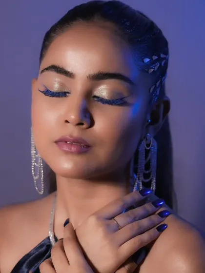 The glitter on the lashes and the metallic blue nails complete this cohesive, high-fashion concept. I teach the importance of attention to every detail.