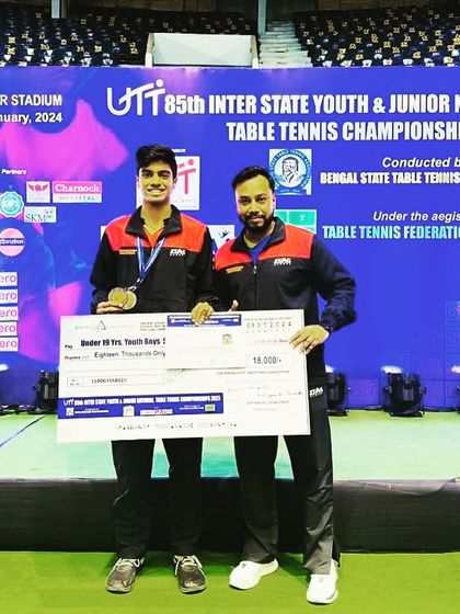 A close-up shot with Aakash K J and his national medal, capturing the coach-player bond that is crucial for success at this level.