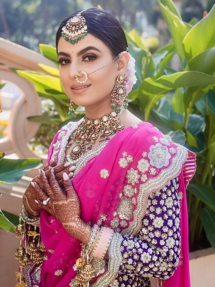 A closer look at the harmonious balance between hair, makeup, and jewellery for this Sikh bride. The floral bun is visible at the back, adding a touch of softness to the overall regal and traditional wedding look.