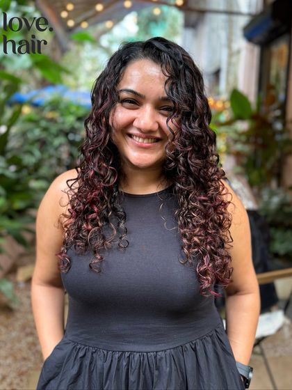 A beautiful smile from a client loving her new no bleach hair colour. The warm tones complement her skin and bring out the definition in her curls.