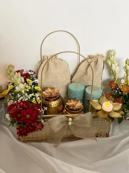 Our Diwali Treats basket, featuring fresh tuberoses and marigolds alongside candles and jute potlis filled with goodies. A perfect blend of fragrance and flavor.