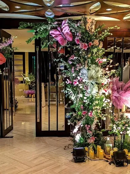 The entrance to this whimsical Sangeet was a floral fantasy, with oversized, colorful butterflies nestled among the blooms, creating a magical welcome for guests.
