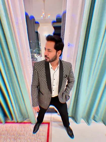 Getting ready, the calm before the storm. A stylish pose in a patterned blazer, moments before I go on to electrify the crowd.
