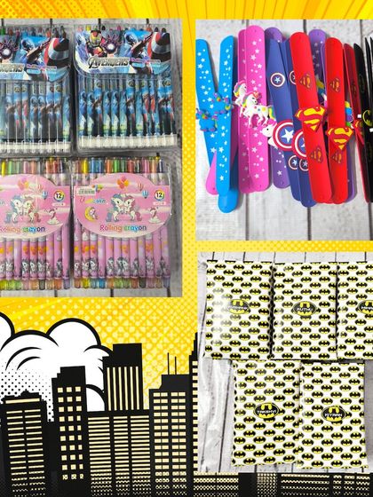 This image shows some of the items that can go into a superhero hamper, like themed rolling crayons, wristbands, and Batman-themed gift boxes.