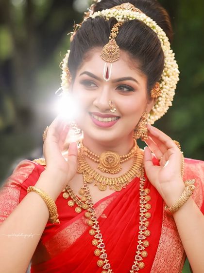 A series dedicated to capturing a divine, traditional look in a striking red saree. These images, shot both in-studio and outdoors, focus on graceful poses and the vibrant color of the attire.