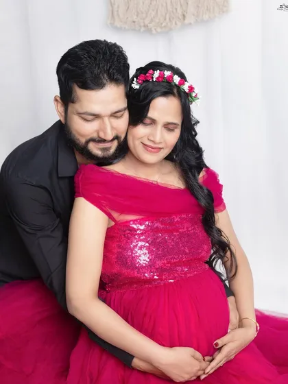 A quiet moment of togetherness. The husband’s gentle embrace around his wife and their baby bump shows the protective and loving 'rishta' you share. Capturing this connection is the heart of my couple sessions.