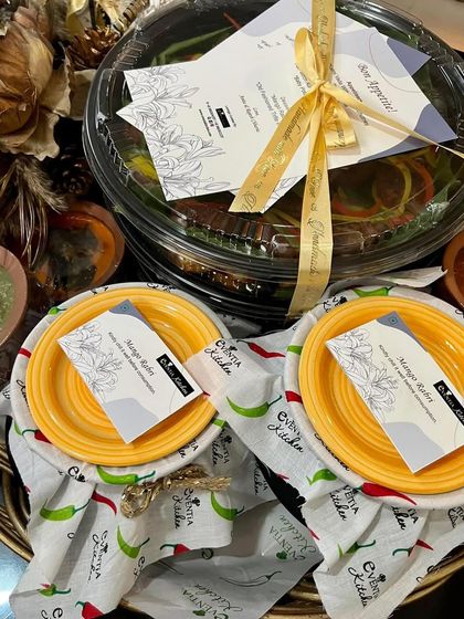 The art of presentation is key to the experience. This image shows how I pack my meal platters with custom-printed menus, branded cards, and elegant ribbons, ensuring the unboxing is as delightful as the food itself.