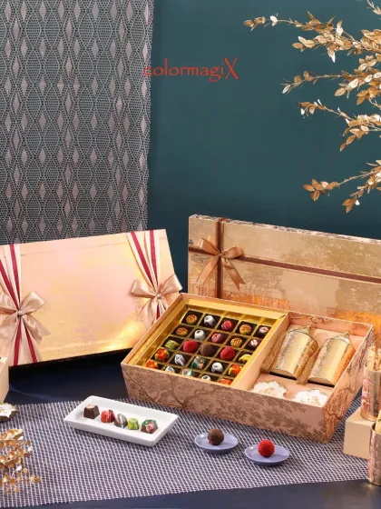 Indulge the senses with our exquisite chocolate and sweets boxes. This opulent gold-foiled hamper contains an assortment of handcrafted chocolates and premium treats, perfect for the discerning connoisseur.