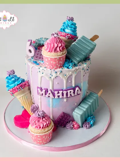 A dessert lover's dream cake for Mahira's 6th birthday. This pastel creation is overloaded with mini cupcakes, ice cream cones, and cakesicles.